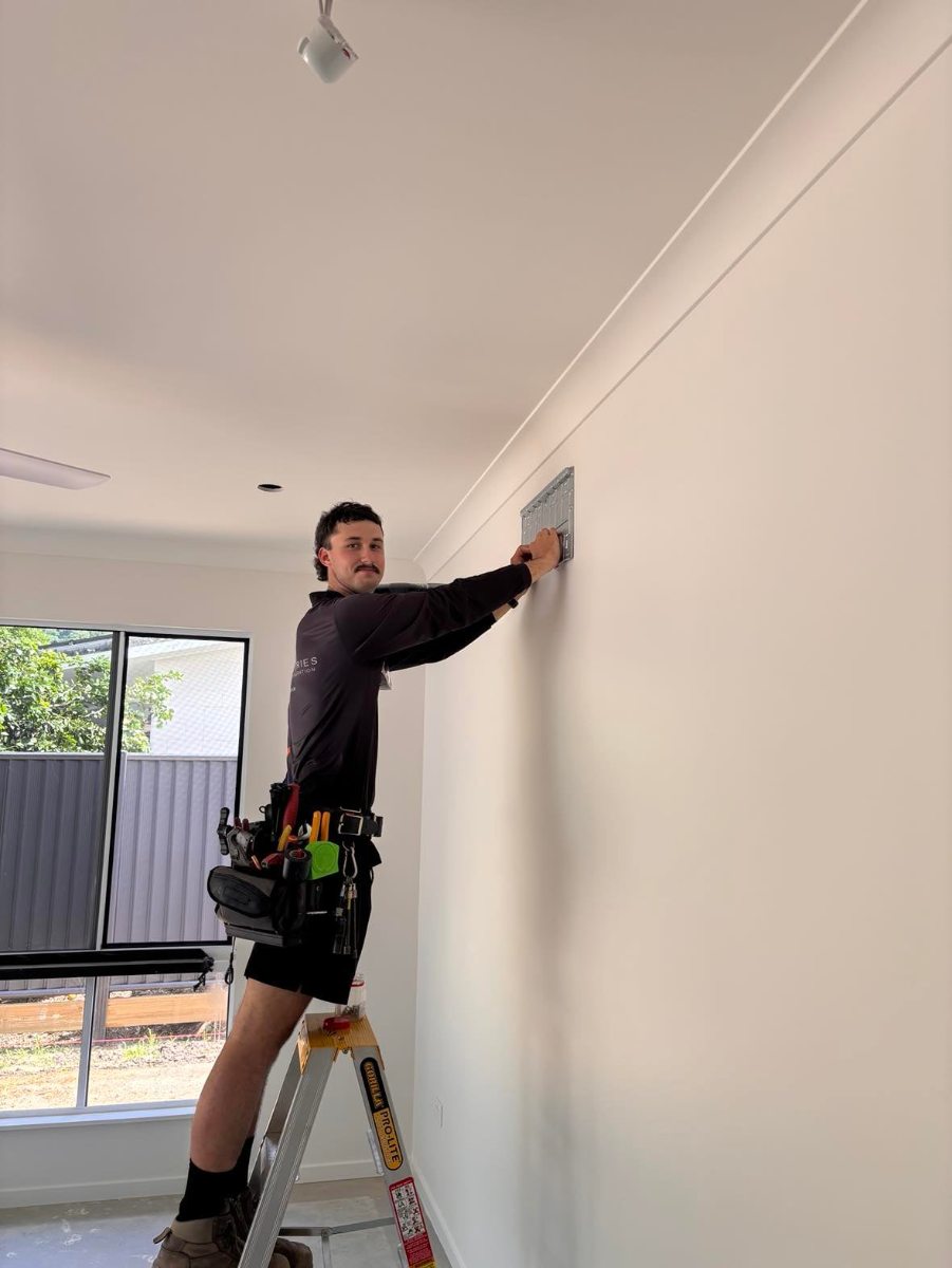 Airtek technician fitting an air conditioner in a new Cairns home