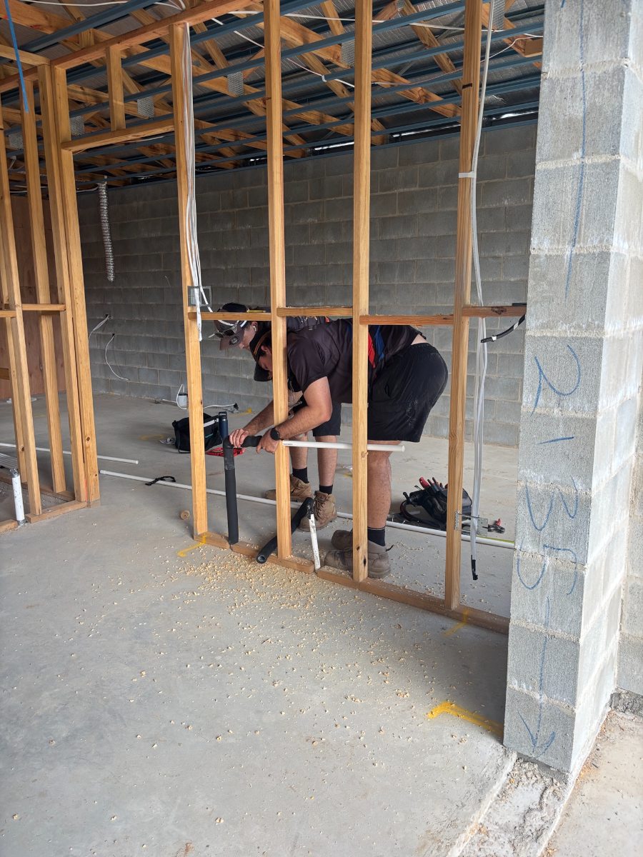 Airtek installing pipework in a framed wall during a Cairns new build