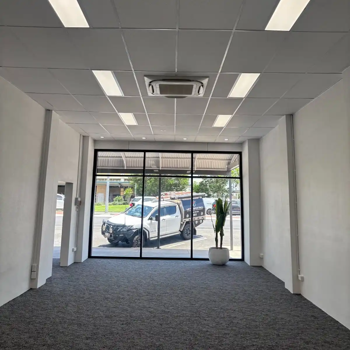 Compact 600x600 ceiling cassette fitted into a suspended ceiling grid in a Cairns office