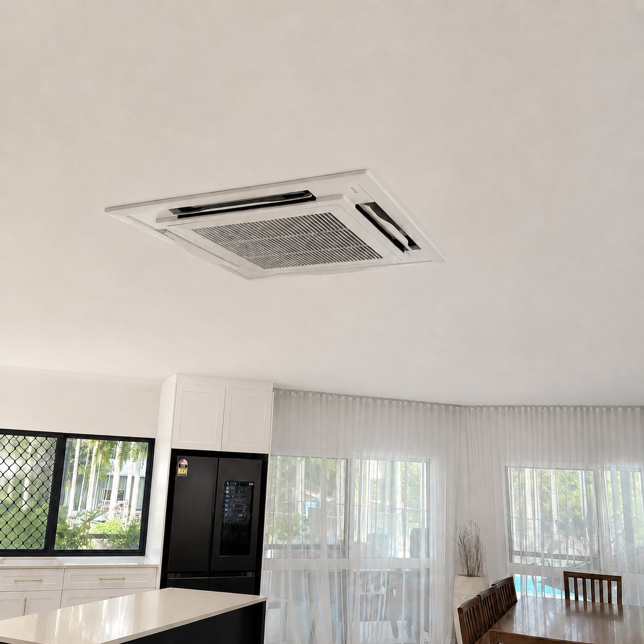 Ceiling cassette air conditioner sitting flush in the ceiling of an open-plan Cairns kitchen and living area