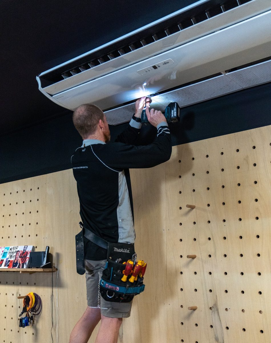 Airtek servicing an under-ceiling air conditioner at a Cairns gym