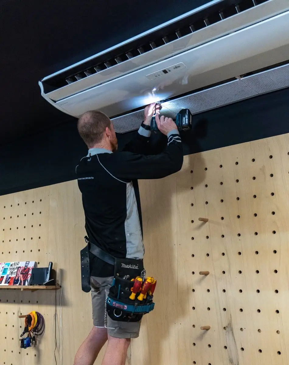 Airtek servicing an under-ceiling air conditioner at a Cairns gym