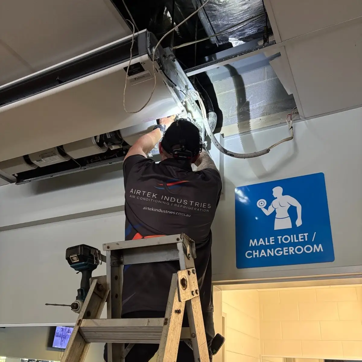 Airtek installing a commercial under-ceiling air conditioner in Cairns