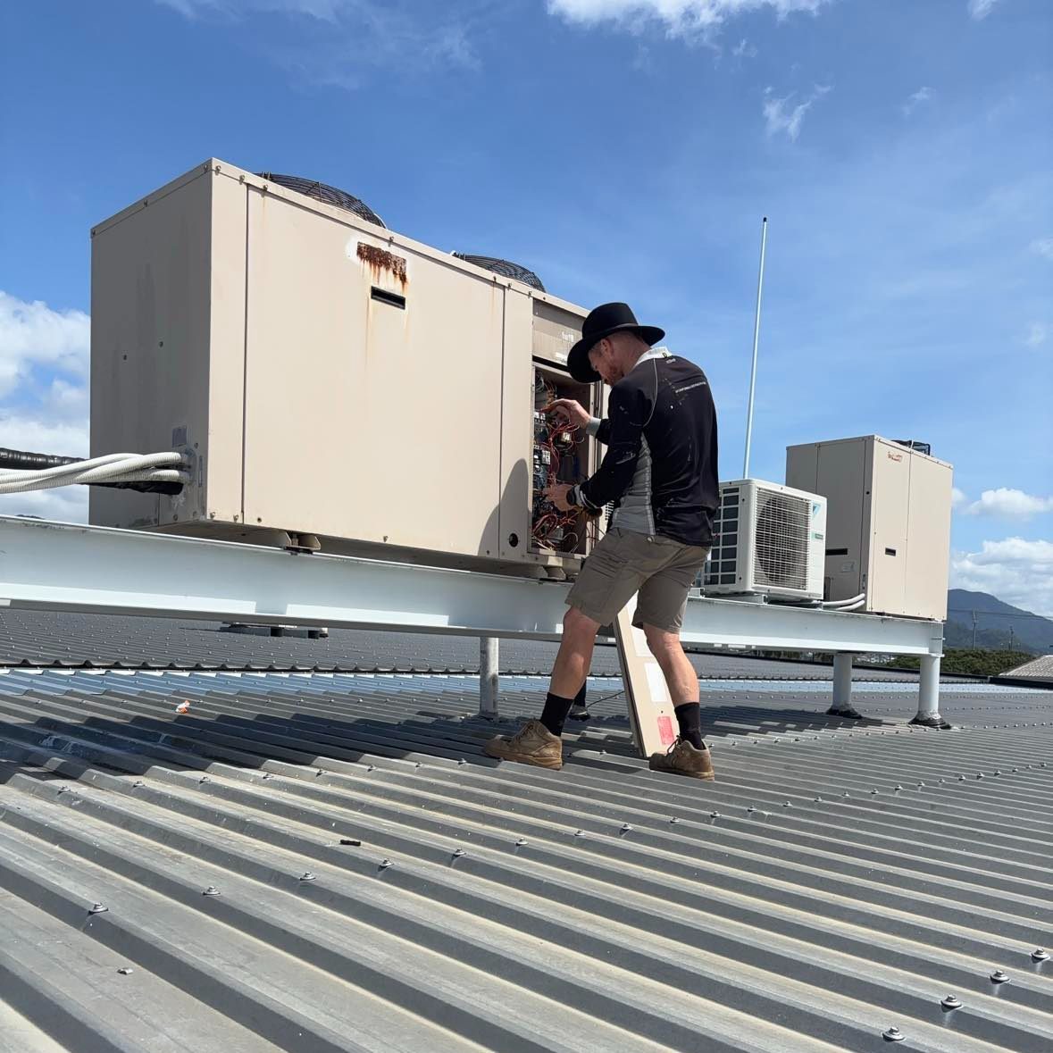 Airtek servicing rooftop air conditioning plant on a Cairns commercial property
